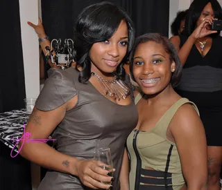 It Takes Two - Toya's sister Anisha "Beedy" Johnson is showing that she's just as stylish at the Garb Boutique grand opening. She's rocking that olive-colored top well.(Photo: Joi Pearson / Joi Pearson Photography)&nbsp;