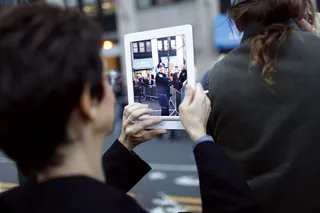 21st Century Protest  - A demonstrator captures scenes of the police near Wall Street. (Photo: Raymond Haddad/BET.com)