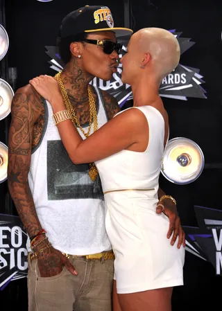 Cutest Couple-Wiz Khalifa and Amber Rose - Have we seen more PDA between a couple before these two? The Pennsylvania natives met via Twitter and became fast friends, Amber, who's a few years older than Wiz, said she initially thought of Wiz as a “little brother,” but fast-forward a year later and Amber told us, “Me and Wiz, we love each other unconditionally. The love that I have for Wiz, and I know this is going to sound weird, is the love that you have for your child — they can do no wrong. No matter what happens or what goes on, that’s your family. And that’s how me and Wiz are. His family is my family, my mom is his mom, his mom is my mom. We love each other so much.” They really are kinda cute, right? (Photo: Gregg DeGuire/PictureGroup)