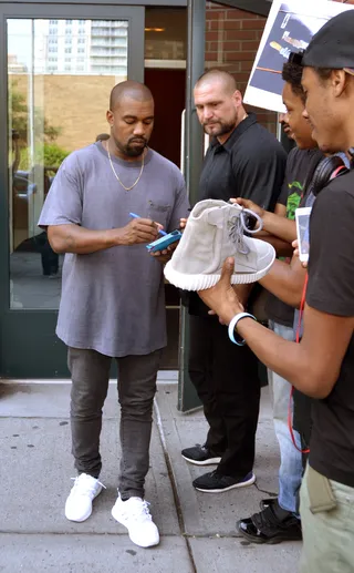 Autograph, Anyone? - Fans wait outside Kanye West's apartment in NYC so that the rapper-producer turned fashion designer can sign their Air Yeezy sneakers. &nbsp;(Photo: TNYF/WENN.com)