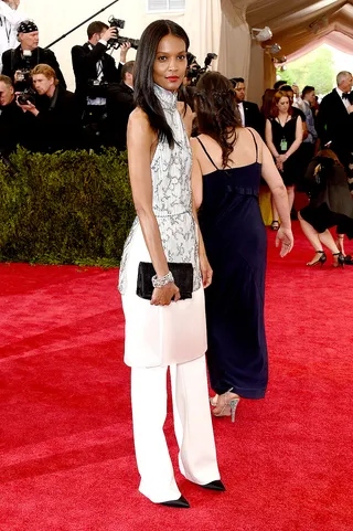 Liya Kebede - The model breaks away from the gown trend and rocks an embellished 3.1 Phillip Lim tunic over crisp white slacks. She finishes her look with sharp black pumps and a scarlet lip.  (Photo: Larry Busacca/Getty Images)