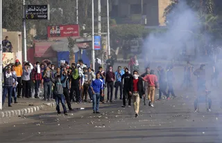 Student Supporters of Morsi Clash With Military in Egypt - Egyptian military forces fired tear gas at student protesters on Dec. 16 outside of the Ain Shams University campus in eastern Cairo in attempts to thwart protesters from reaching the defense ministry. Many of the students were in support of ousted former president Mohamed Morsi.&nbsp;(Photo: REUTERS/Stringer)