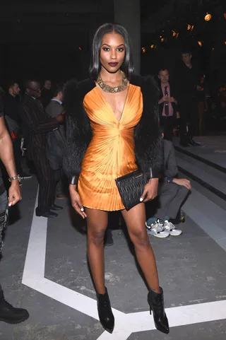 Sharam Diniz - The model is a standout at the show in a vibrant orange frock and black fur. Her 'fit is totally on trend this season!(Photo: Nicholas Hunt/Getty Images for H&amp;M)