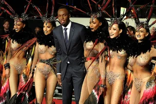 Suited and Booted - Usain Bolt was surrounded by beautiful women during the world premiere of I AM BOLT at ODEON Leicester Square in London. (Photo: Photoshot, PacificCoastNews)