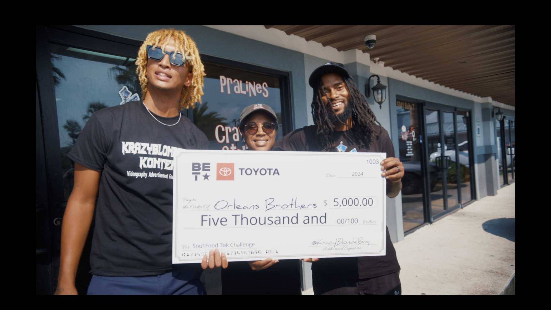 Orleans Brothers owners with check