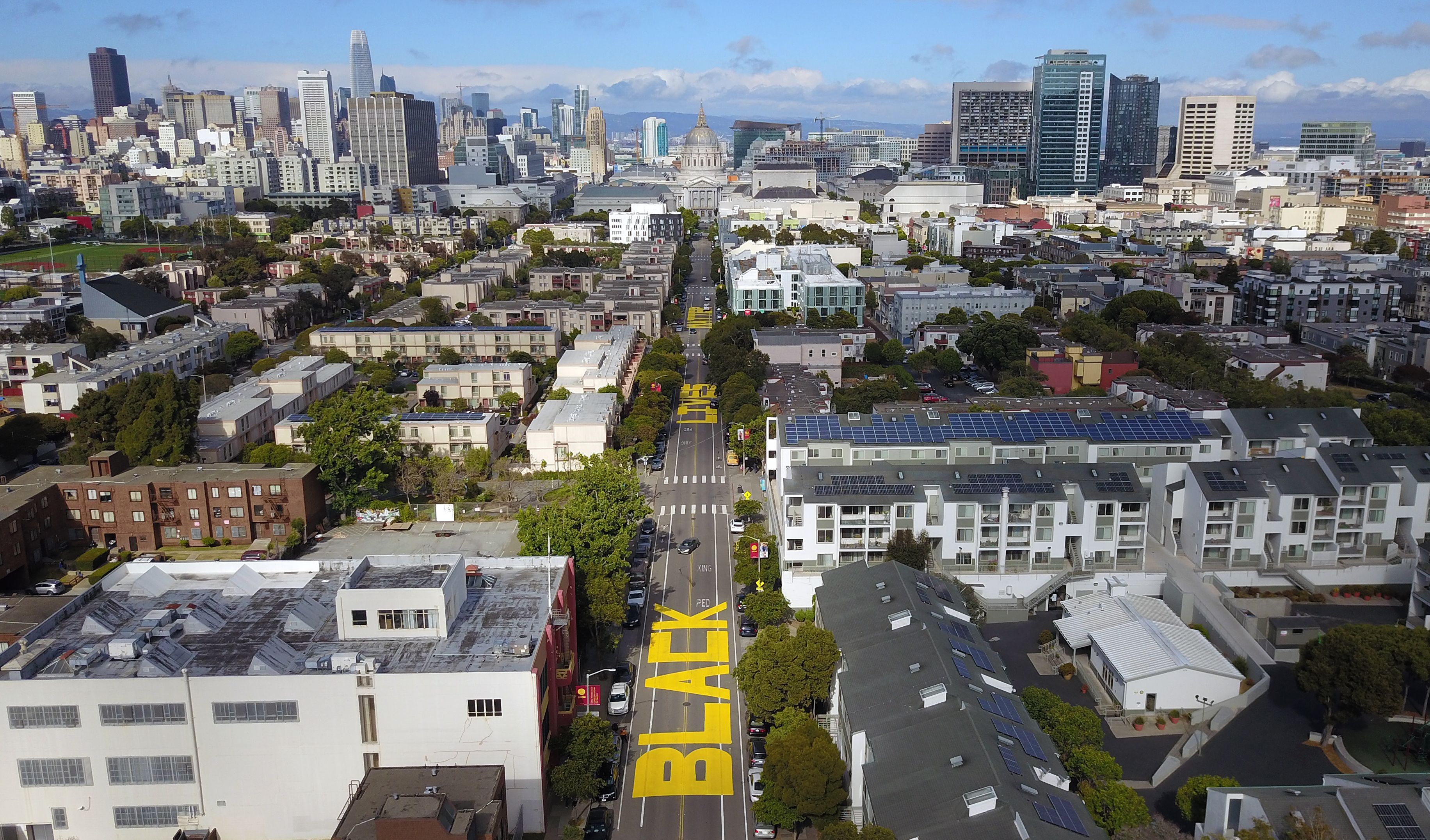 An aerial photo shows a giant street mural reading "Black Lives Matter" spanning three city blocks near City Hall in San Francisco, California on June 12, 2020. - The May 25 killing of George Floyd, an African American, by a white police officer in Minneapolis has ignited mass protests for racial justice and police reform across the United States. (Photo by Josh Edelson / AFP) (Photo by JOSH EDELSON/AFP via Getty Images)