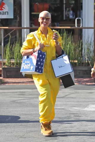 Walking On Sunshine - Amber Rose was captured in a baggy yellow jumpsuit and Timberland boots during a shopping trip to Los Angeles’s Fred Segal.(Photo: Beiny/Slater/WENN.com)
