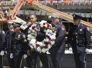 Carrying the Wreath - President Barack Obama prepares to lay the wreath.(Photo: AP Photo/Charles Dharapak)