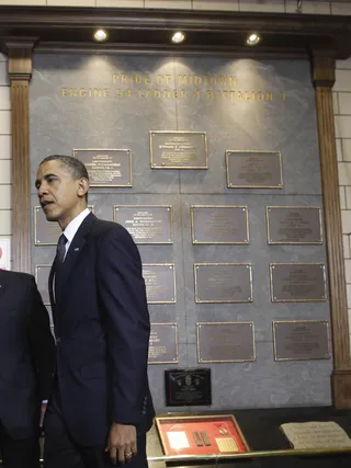 The Wall of Honor - The president finishes viewing a bronze memorial plaque for the 15 men the firehouse lost as a result of the terror attack.(Photo: AP Photo/Charles Dharapak)