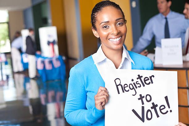 Woman holding Get Registered sign