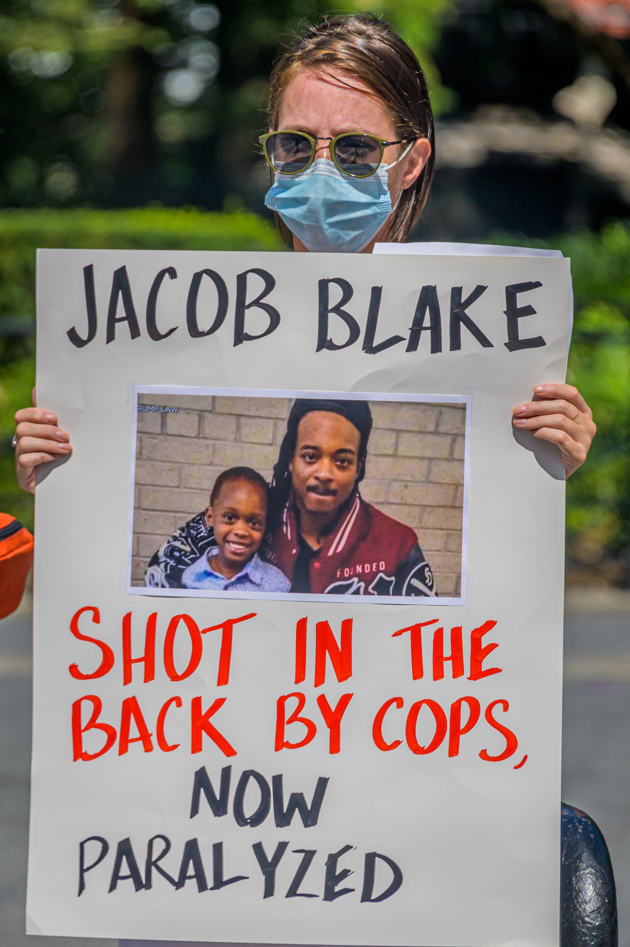 MANHATTAN, NEW YORK, UNITED STATES - 2020/08/30: A participant holding a Jacob Blake sign at the protest. Gays Against Guns (GAG), the direct action, gun violence prevention group formed by members of LGBTQ communities and allies, held a day of action protest in New York City’s Union Square to call attention to the violent, bloody cycle of death that Americans are witnessing on a constant repeat setting: The Cycle of Death that has emerged at the nexus of white supremacist policing, the Black Lives Matter movement, the Alt-Right, white supremacist militia movement, and American gun culture. (Photo by Erik McGregor/LightRocket via Getty Images)