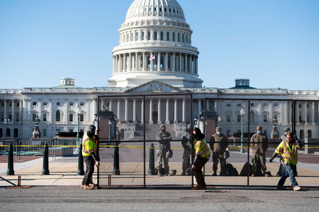 UNITED STATES - JANUARY 7: Workers install more robust fencing along the east side of the U.S. Capitol on Thursday morning, January 7, 2021, following the riot at the Capitol the day before. (Photo By Bill Clark/CQ-Roll Call, Inc via Getty Images)