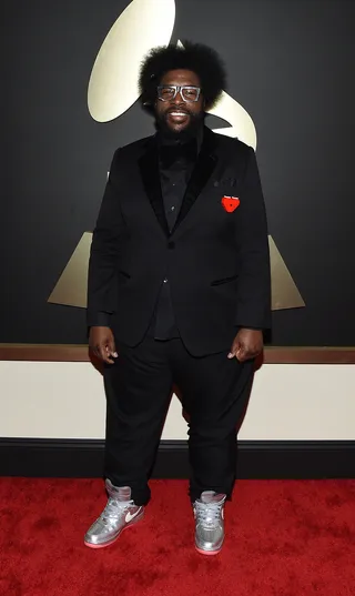 Questlove - What’s not to love about his quirky style? A black suit and silver Nike dunks are always a “do” in our book.  (Photo: Larry Busacca/Getty Images for NARAS)