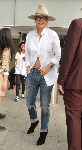 Pop! - Rita Ora is all smiles rocking a bright orange lip as she arrives at Heathrow Airport in London.(Photo: Palace Lee, PacificCoastNews)