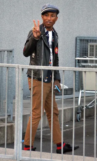 Peace Peeps - Pharrell Williams greets fans as he arrives at Dublin Airport to catch a flight after performing at Croke Park in Ireland.&nbsp;(Photo: WENN.com)