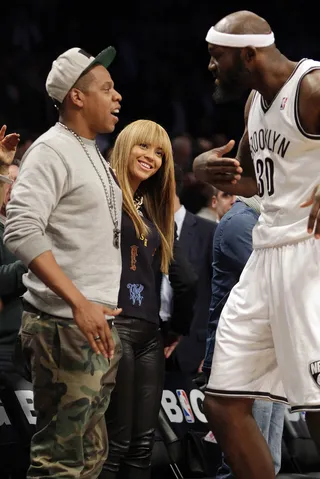 Sideline Action - Jay-Z and Beyoncé react while Brooklyn Nets player Reggie Evans walks to the bench after the game against the New York Knicks at the Barclays Center in Brooklyn. The Nets defeated the Knicks 96-89 in overtime.&nbsp;&nbsp;(Photo: UPI/John Angelillo /LANDOV)