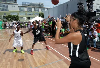 Mismatch in the Paint - With a smaller player (the much smaller Bobb'e J. Thompson) on him Chris Brown calls for the ball. Old school ballers would call that &quot;mouse in the house.&quot;(Photo: Ben Horton/Getty Images for BET)