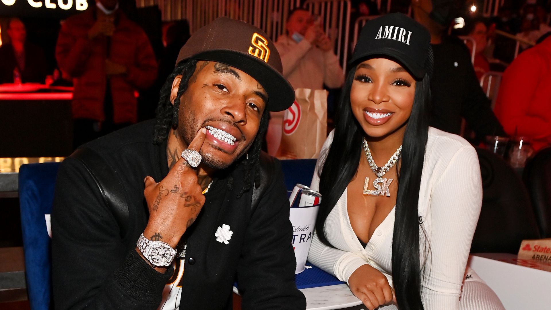 Coca Vango and Light Skin Keisha attend the game between the Orlando Magic and the Atlanta Hawks at State Farm Arena on December 22, 2021 in Atlanta, Georgia. 