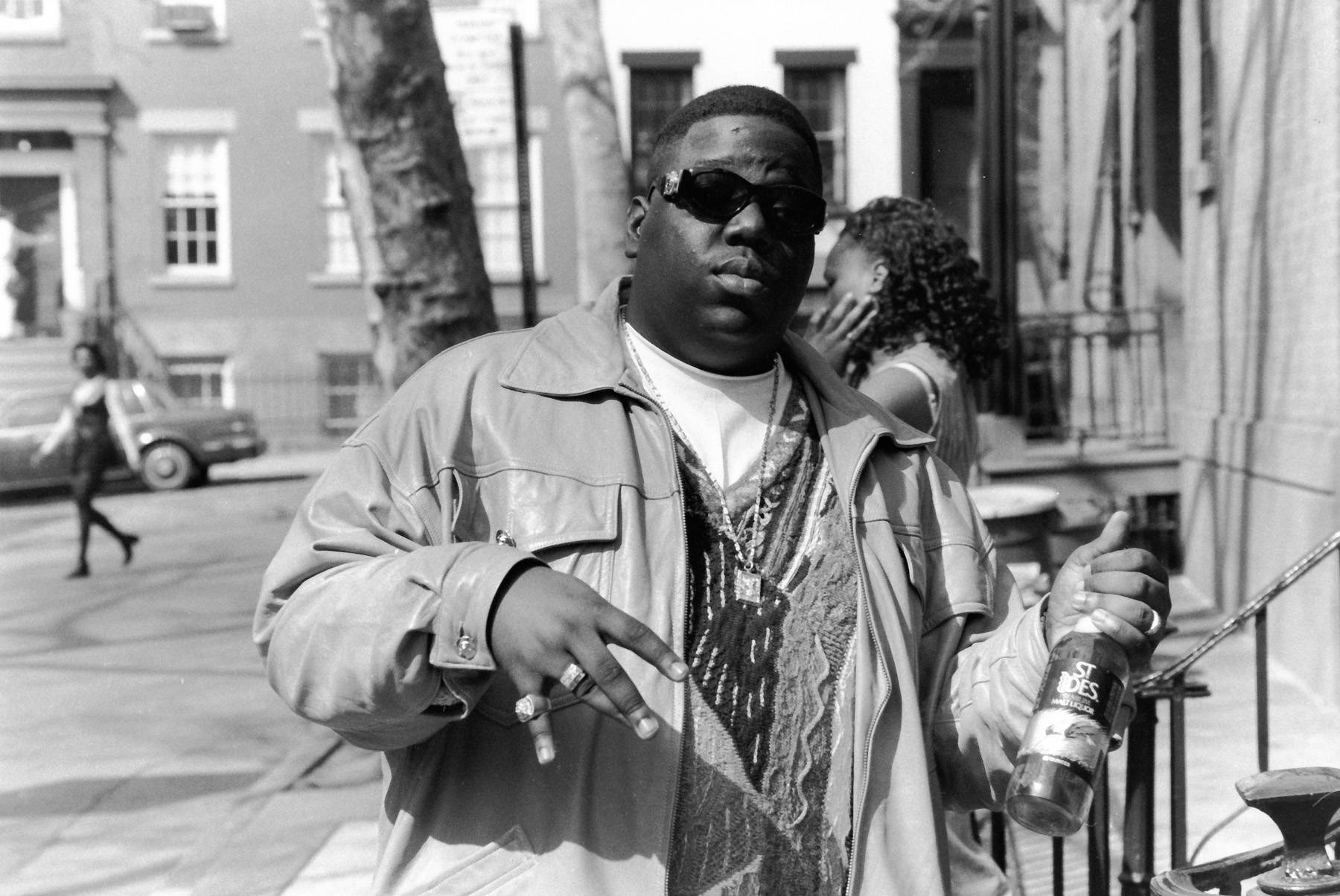 American rapper Biggie Smalls (also known as the Notorious B.I.G., born Christopher Wallace, 1972 - 1997) holds a bottle of St. Ides malt liquor, New York, New York, 1995. (Photo by Adger Cowans/Getty Images)