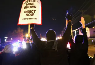 We Demand Justice - Demonstrators are confronted by police as they block a street during a protest ahead of the grand jury announcement. (Photo: Scott Olson/Getty Images)