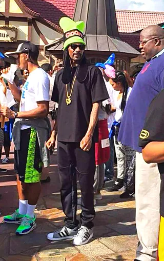 Goofin' Around - Snoop Dogg&nbsp;has some fun with his family wearing a Goofy hat while visiting Disney World's Magic Kingdom in Florida.(Photo: StarFeine.com / Splash News)