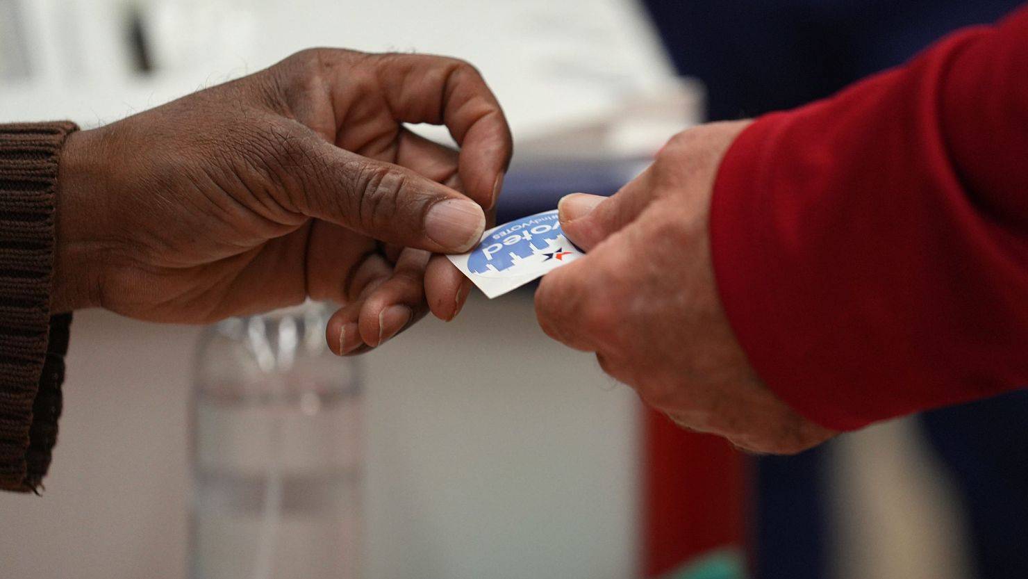 Hands holding 'I Voted' Sticker