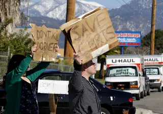 Pro-Dorner Protestors Rally at LAPD HQ - Dozens gathered in front of the Los Angeles police headquarters Saturday to protest the LAPD's tactics saying they believe Christopher Dorner was right to call the department out as racist. They also disagreed with the manhunt that led to the former officer's death. (Photo: REUTERS/Alex Gallardo)