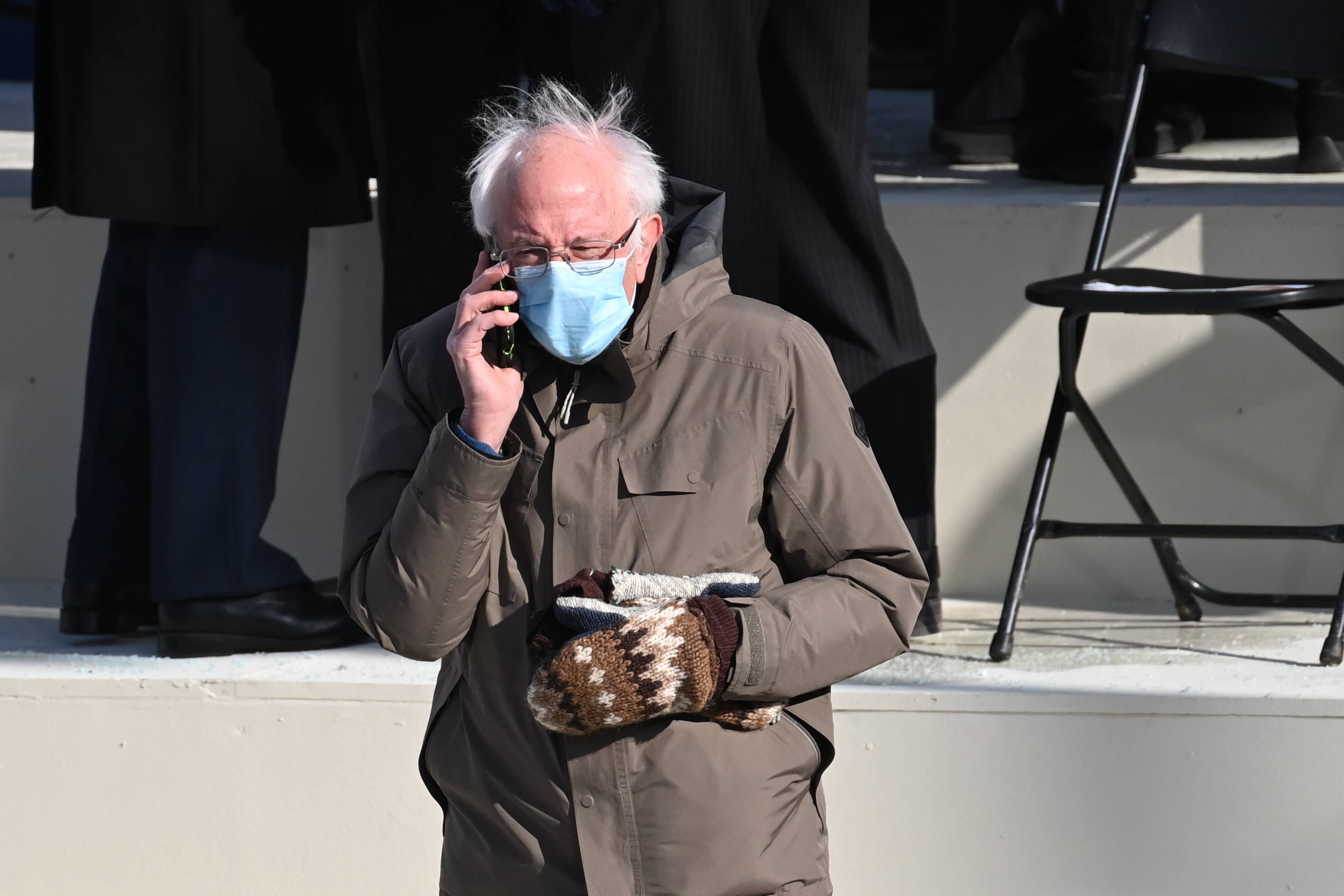 Vermont Senator Bernie Sanders is seen on the phone before US the inauguration of Joe Biden as the 46th US President on January 20, 2021, at the US Capitol in Washington, DC. (Photo by SAUL LOEB / POOL / AFP) (Photo by SAUL LOEB/POOL/AFP via Getty Images)