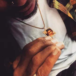 Close to My Heart - Brown shows off a gold pendant on his chain featuring a photo of Royalty. (Photo: Chris Brown via Instagram)