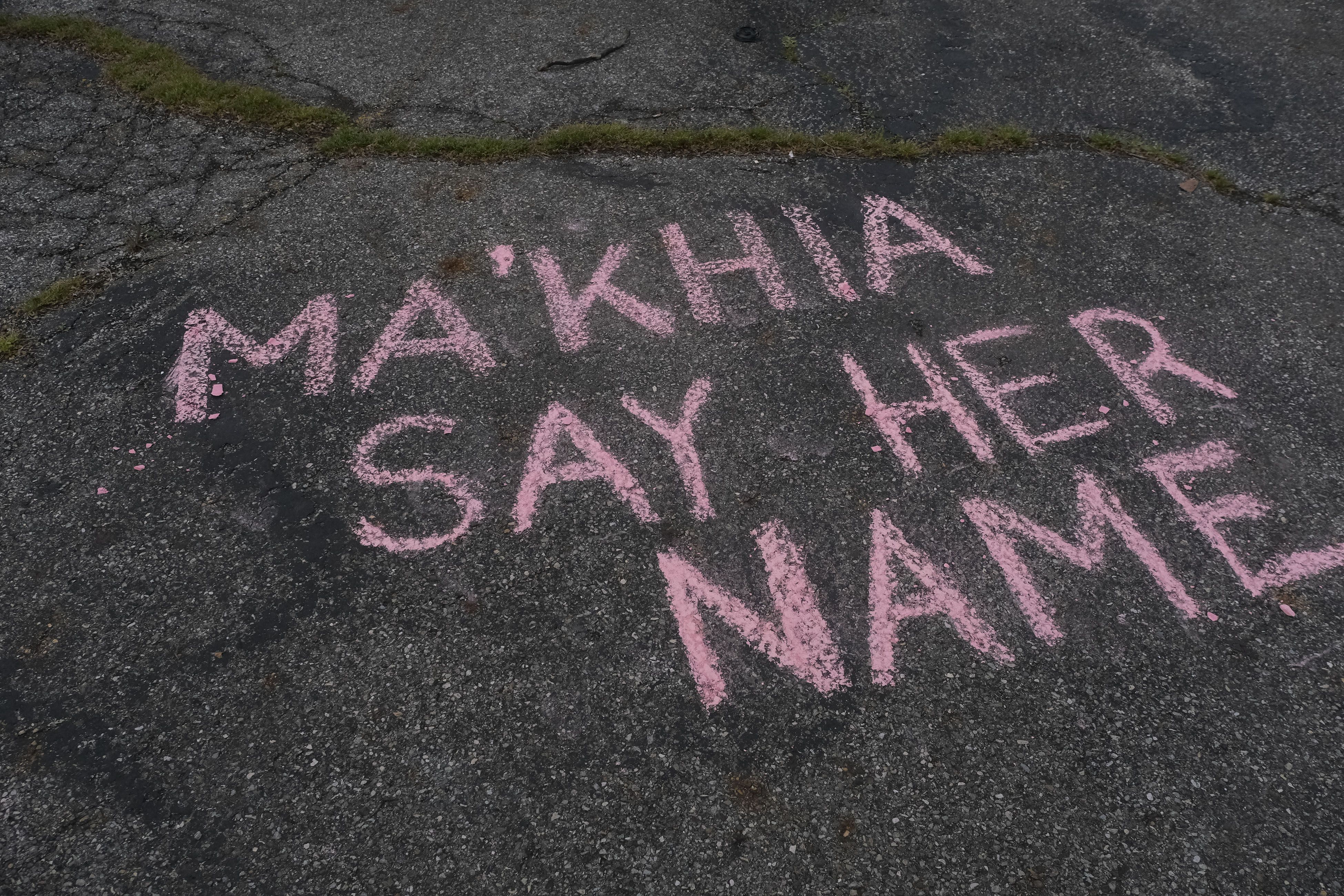 Supporters write messages in chalk at a vigil in Columbus, Ohio on April 21, 2021 in memory of MaKhia Bryant, 16, who was shot and killed by a Columbus Police Department officer. - Police in the US state of Ohio fatally shot a Black teenager who appeared to be lunging at another person with a knife, less than an hour before former officer Derek Chauvin was convicted of murdering George Floyd. The shooting occurred at a tense time with growing outrage against racial injustice and police brutality in the United States, and set off protests in the city of Columbus. (Photo by Jeff Dean / AFP) (Photo by JEFF DEAN/AFP via Getty Images)