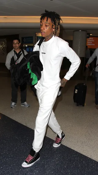 White Out - Wiz Khalifa was spotted arrive at LAX in this all white 'fit.(Photo: WENN.com)