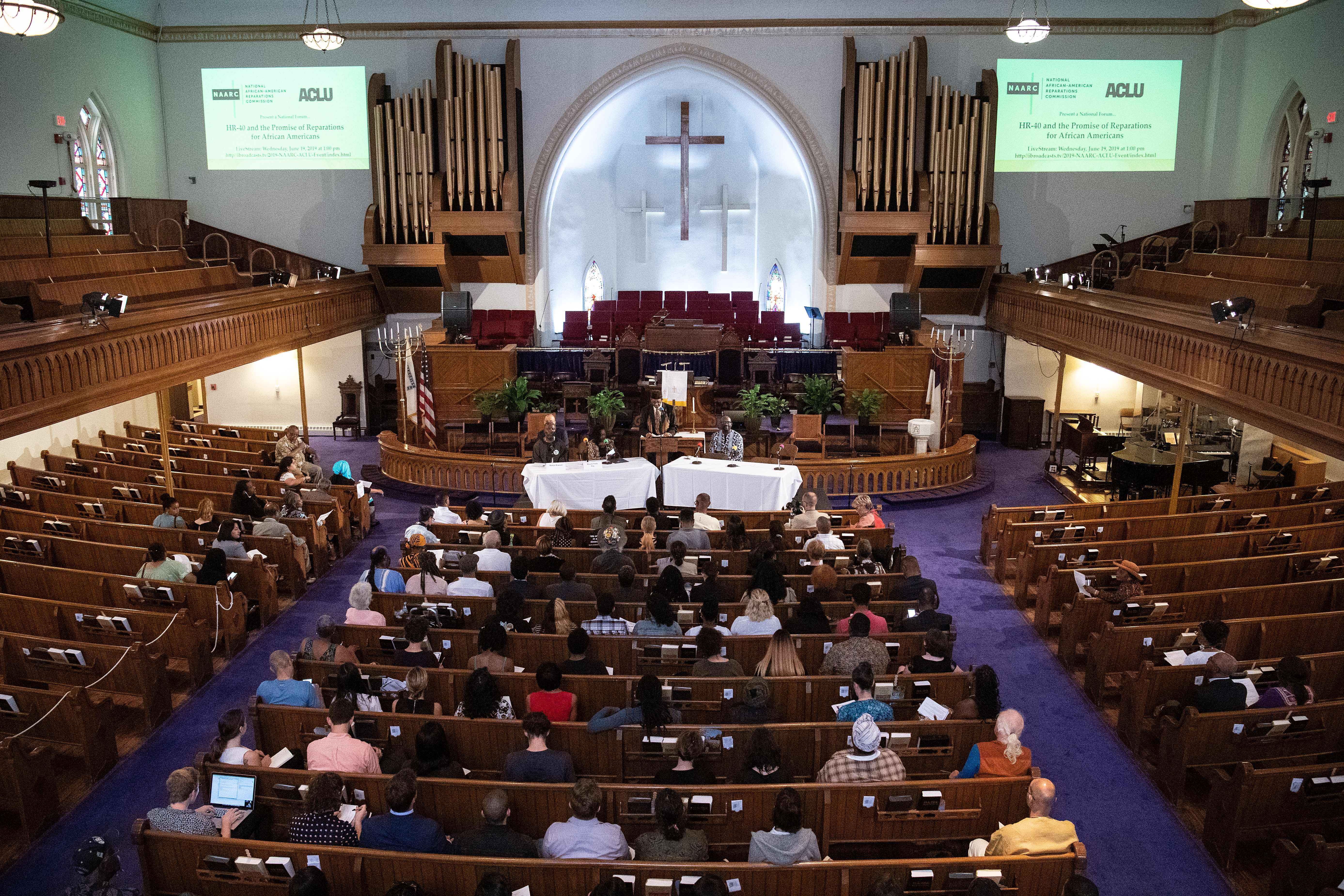 People attend the The National African American Reparations Commission (NAARC) and the American Civil Liberties Union's forum to discuss "reparations as the country continues to reel from the impact of slavery and its legacy," including the "Commission to Study and Develop Reparation Proposals for African-Americans Act," at the Metropolitan AME Church in Washington, DC, on June 19, 2019. (Photo by NICHOLAS KAMM / AFP)        (Photo credit should read NICHOLAS KAMM/AFP via Getty Images)