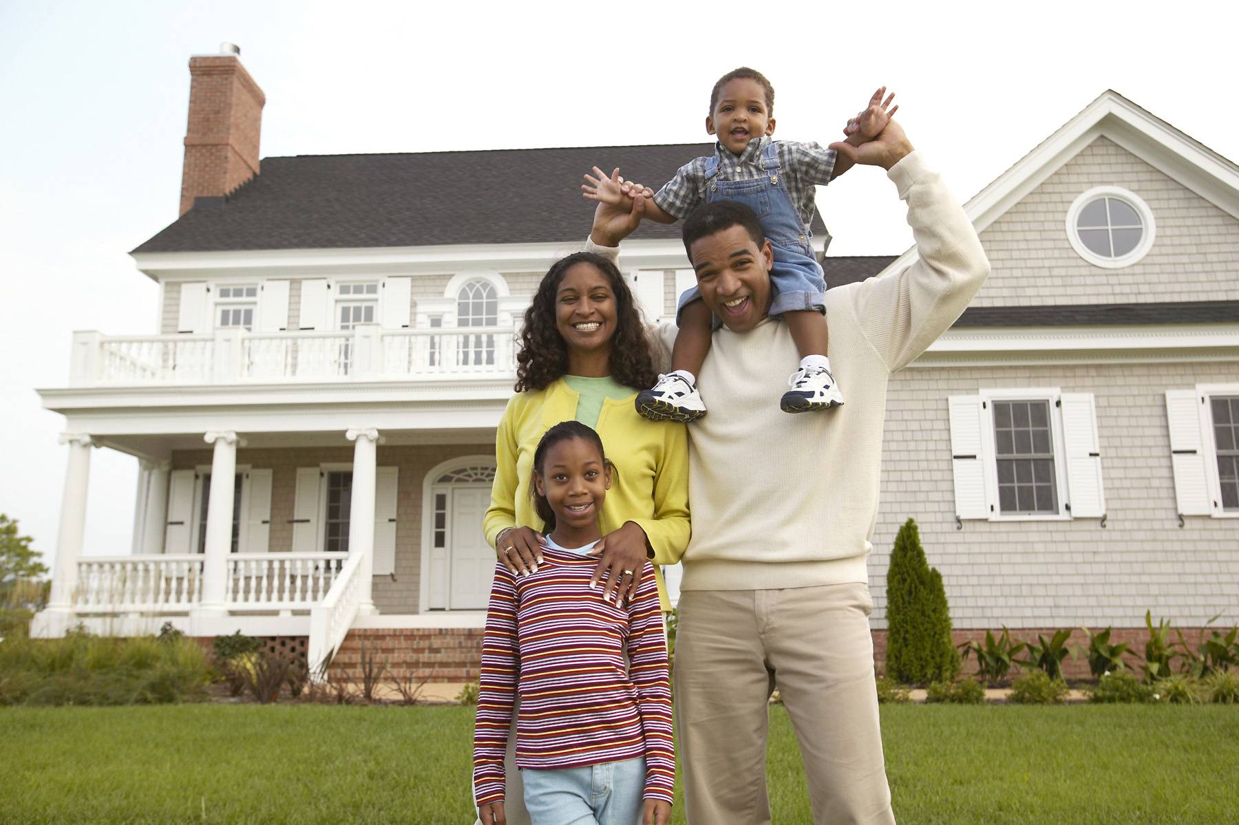 family in front of house