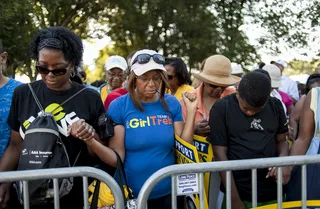 Prayer - A group of women and a young boy hold hands in prayer upon arriving to the National Mall. (Photo: Pete Marovich/Getty Images)