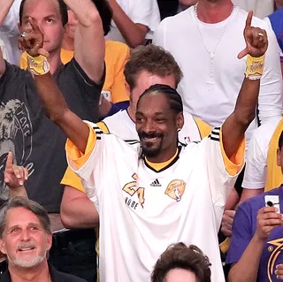 Snoop - Snoop keeps a Lakers reference in his lyrics and on his Twitter. The West Coast repper also designed some purple and yellow-inspired sneakers for Adidas.&nbsp;(Photo: Noel Vasquez/Getty Images)