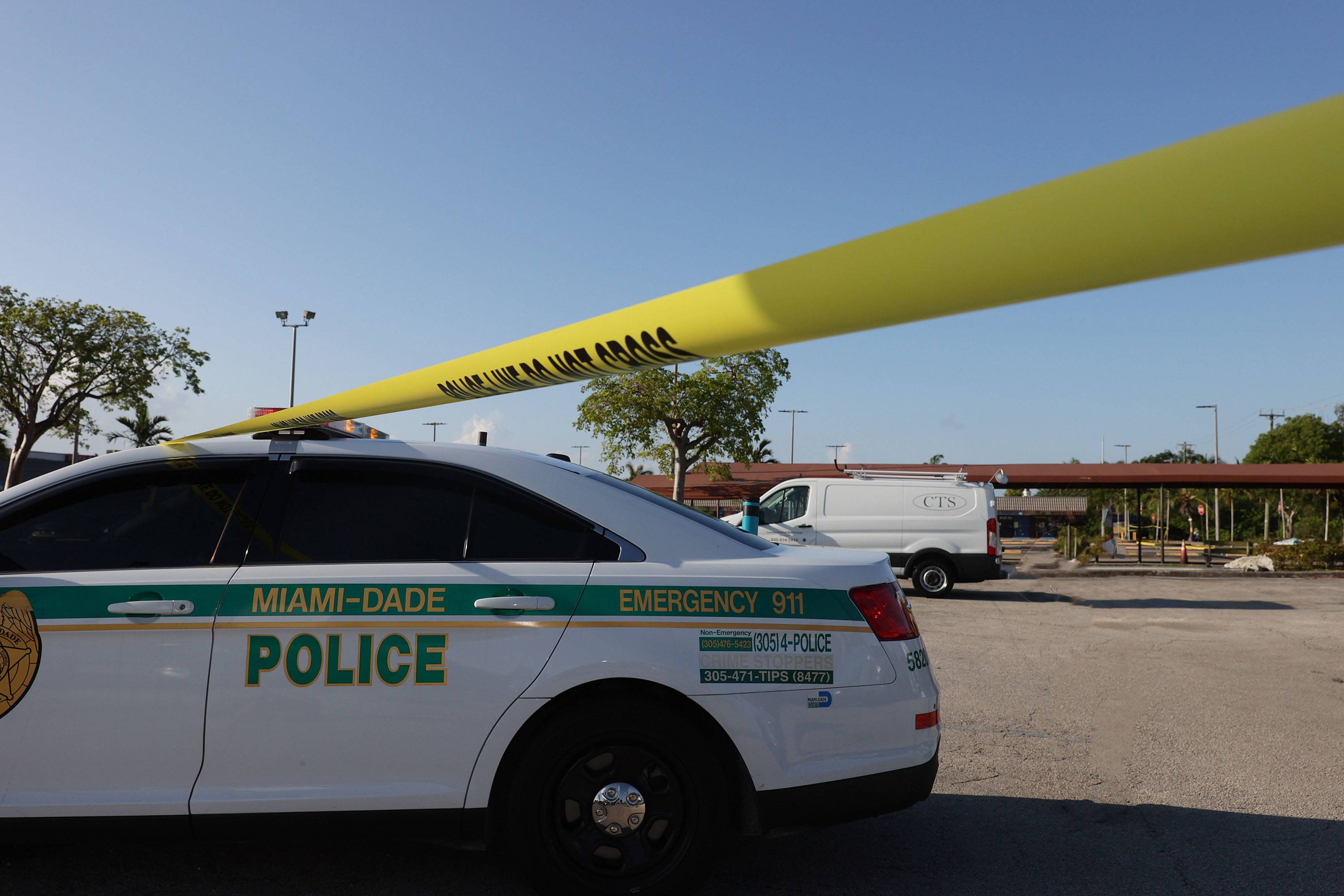 HIALEAH, FLORIDA - MAY 30: A Miami-Dade police officer stands near where a mass shooting took place outside of a banquet hall on May 30, 2021 in Hialeah, Florida. Police say that two people died, and an estimated 20 to 25 people were injured after the shooting early on Sunday, May 30 at a banquet hall, which was rented out for a concert. (Photo by Joe Raedle/Getty Images)