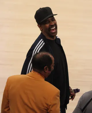 Legend Meets Legend - Denzel Washington shares a hearty laugh with NBA great and legendary Knicks player Walt "Clyde" Frazier at halftime during the Lakers vs. Knicks at the Staples Center in downtown Los Angeles.(Photo: London Ent/Splash News)