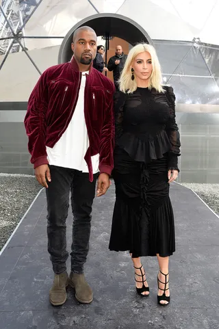 Louis Vuitton Dons - This is perhaps Kim’s most covered up look of the week. The long-sleeved ruffled black top and pencil skirt were from the Givenchy fall collection. The top featured sheer insets and a peplum.&nbsp;(Photo: Pascal Le Segretain/Getty Images)