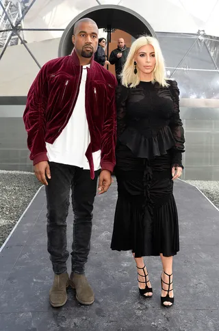 The Un-American Idols - Kanye West and Kim Kardashian pose outside of the Louis Vuitton show during Paris Fashion Week Fall/Winter 2015.(Photo: Pascal Le Segretain/Getty Images)