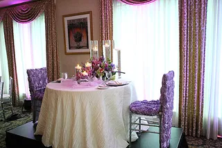 Romantic Setting - We're sure Toya was specific about the way she wanted her wedding reception to look. The place settings and seats were beset with lilac roses. (Photo: Cornell Wheeler)