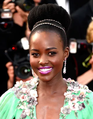 Lupita Nyong’o - This elegant bun turns your natural into a crown. Use a sponge roll if you need more volume and accent it with a jeweled headband that will shimmer and shine all night.&nbsp; (Photo: Clemens Bilan/Getty Images)