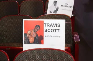 Rodeo Seat - Travis Scott has a funky spot/So he won't get flustered/Not to mention/He's in front of DJ Mustard  (Photo: Bennett Raglin/Getty Images)