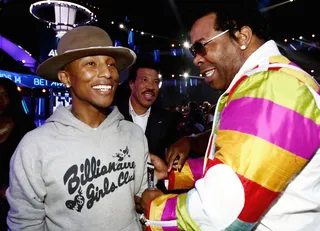 Impeccable Style - Pharrell and Busta Rhymes exchanged pleasantries as they were walking towards their seating. Could we be looking at the start of another "Pass the Courvoiseir"?  (Photo: Johnny Nunez/BET/Getty Images for BET)