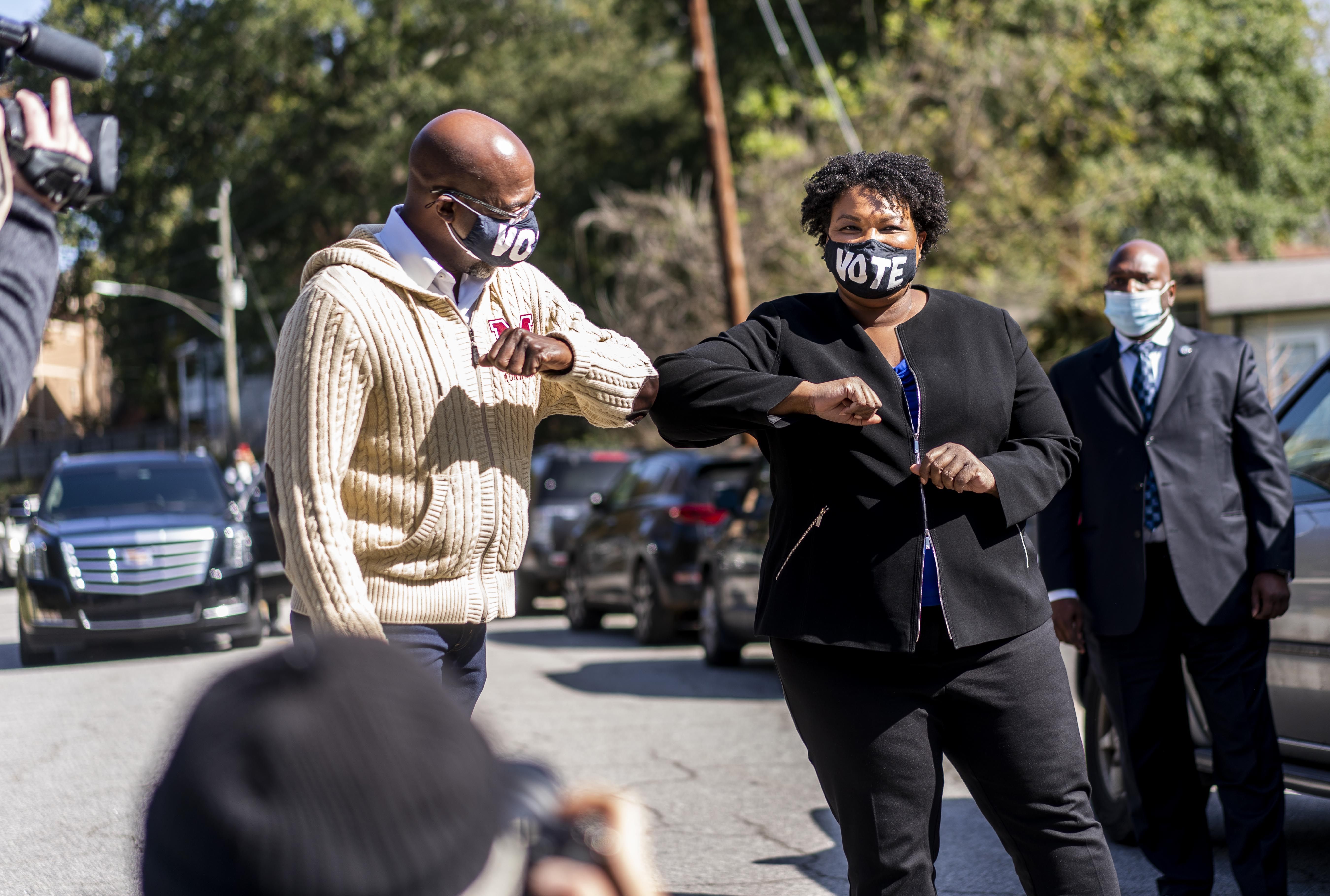 ATLANTA, GEORGIA - NOVEMBER 3, 2020: On Election Day in Georgia's DeKalb County, Democratic US Senate candidate Reverand Raphael Warnock, pastor of Ebenezer Baptist Church, and former Georgia House Minority Leader Stacey Abrams speak to voters at the Coan Recreation Center in Atlanta, Georgia on Tuesday November 3, 2020. (Photo by Melina Mara/The Washington Post)