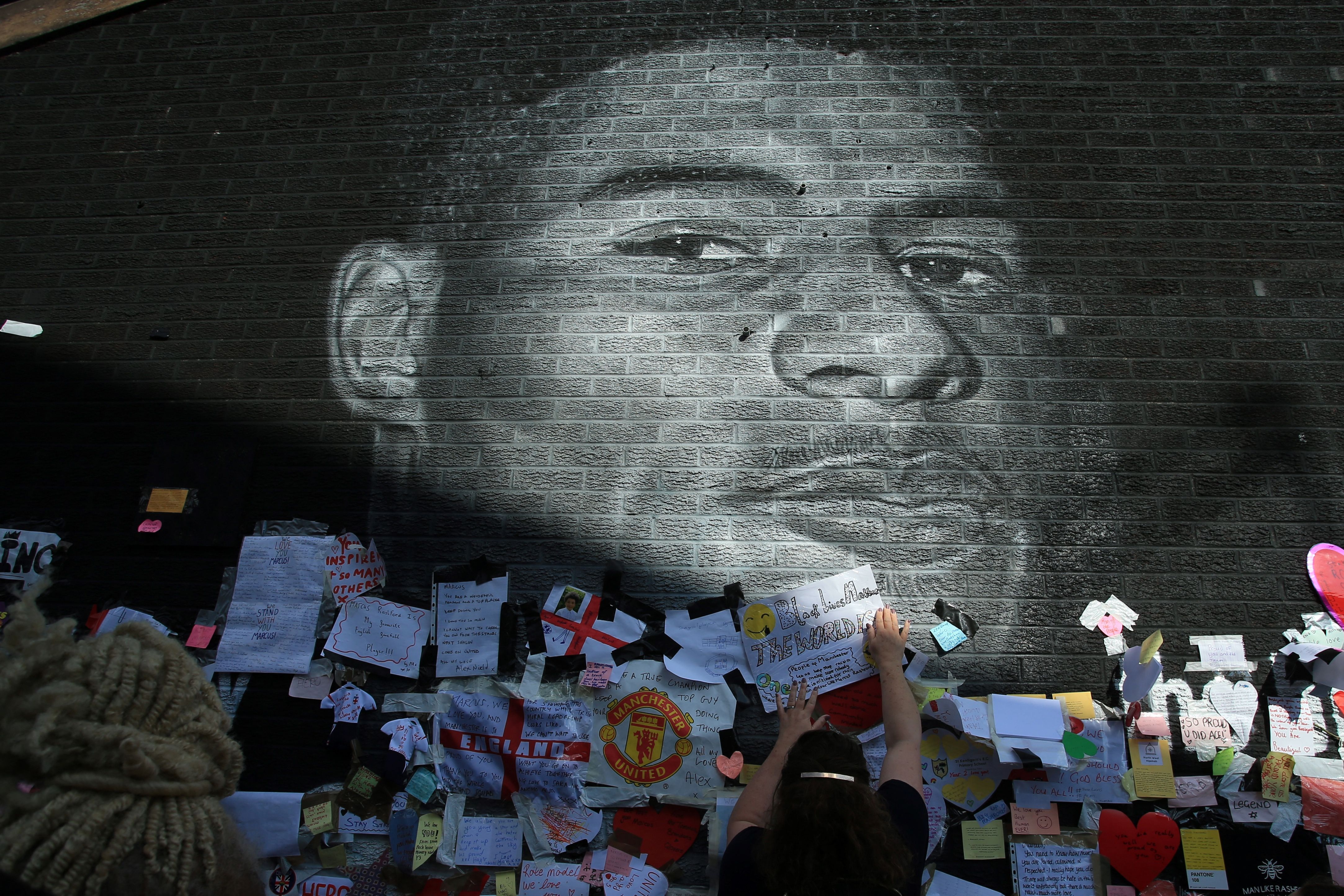 Messages of support adorn a mural of England forward Marcus Rashford after it was defaced on July 13, 2021 in Manchester, northwest England. - The mural was vandalised on July 12 after the England football team lost the UEFA Euro 2020 final. (Photo by Lindsey Parnaby / AFP) (Photo by LINDSEY PARNABY/AFP via Getty Images)