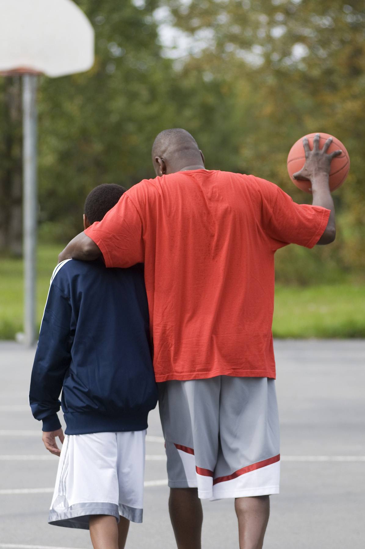 Father and son walking together at a park