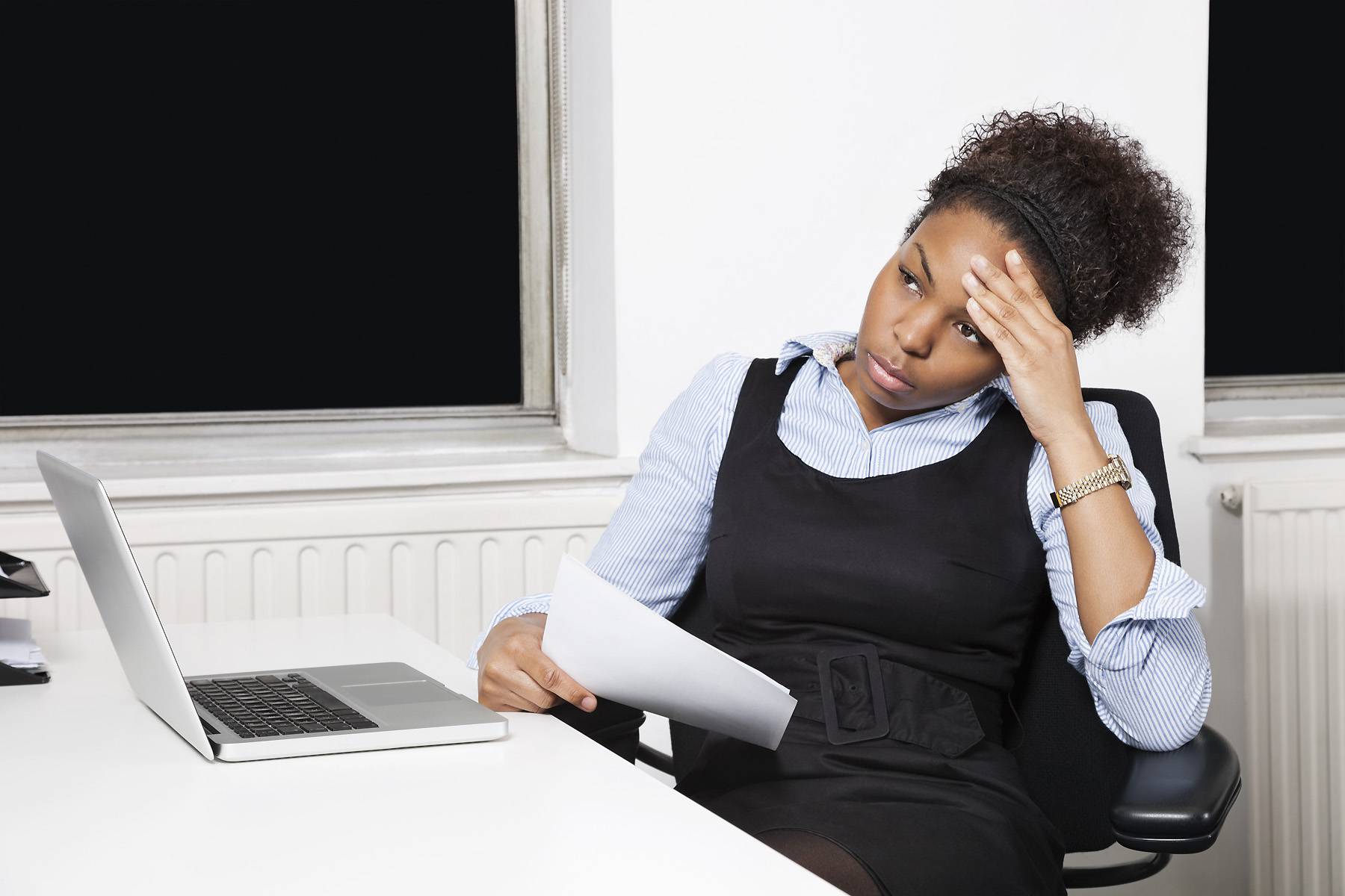 Black businesswoman in front of desk