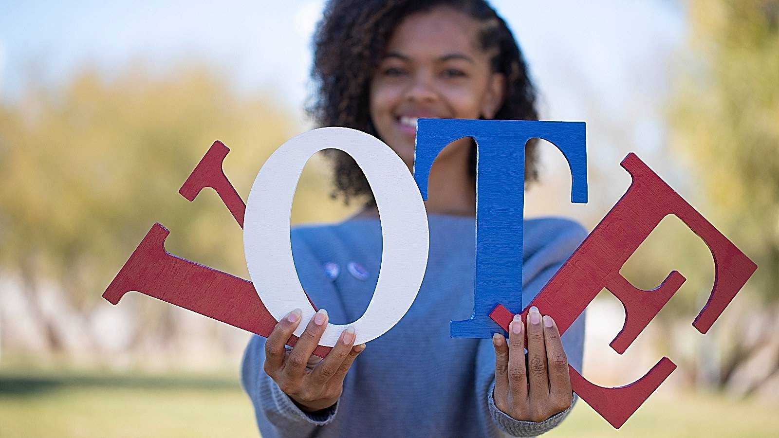 Black woman voting sign