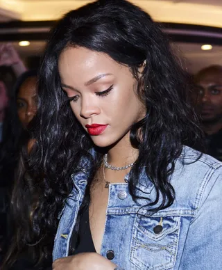 Rihanna  - Jet black curls and a vibrant red lip are a lethal combination. Remember to keep your base simple and brows groomed like Rih Rih&nbsp;does here.&nbsp;   (Photo: Raphael Dias/Getty Images for Budweiser)