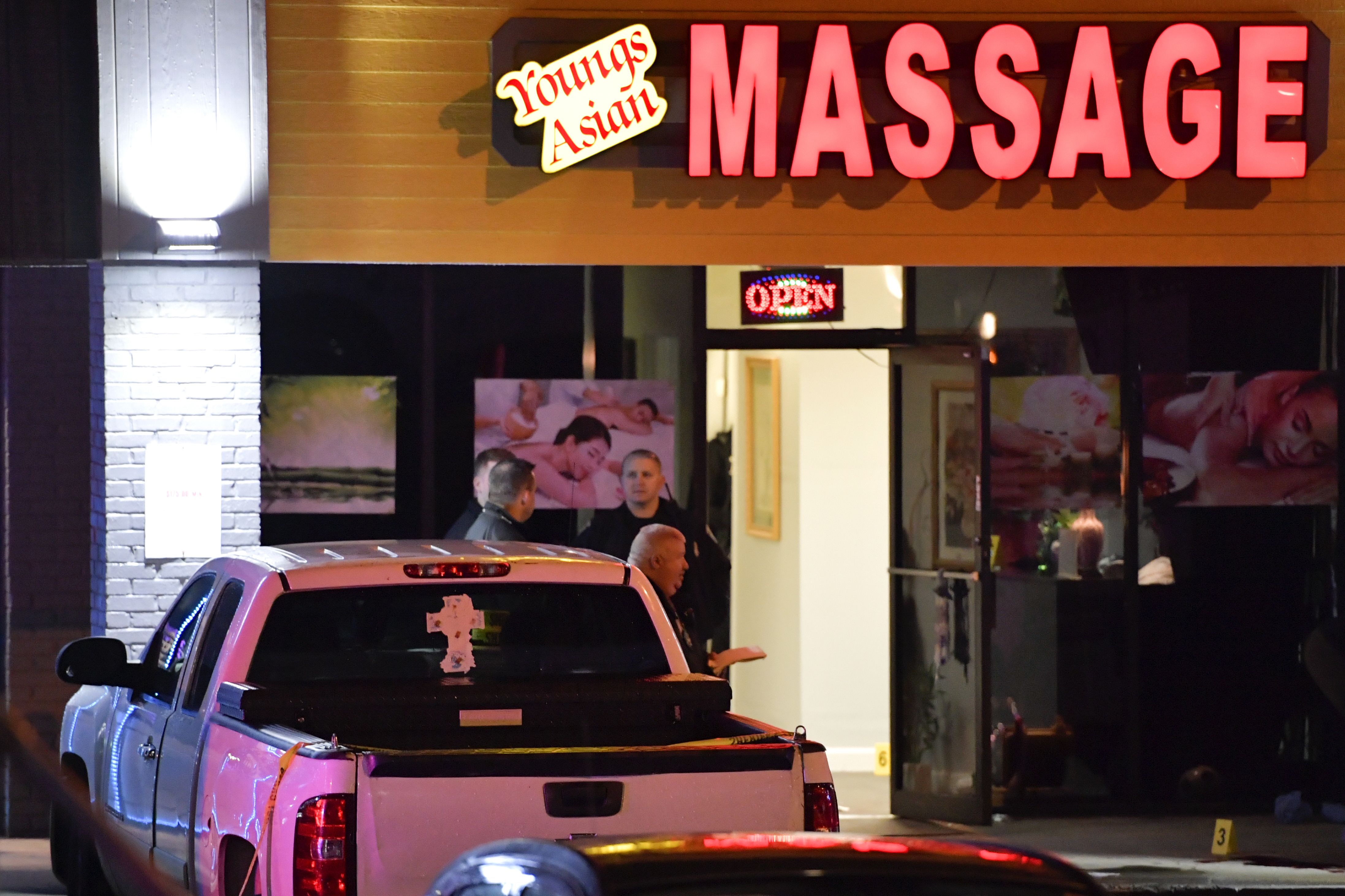 CORRECTS DATELINE TO ACWORTH INSTEAD OF WOODSTOCK - Authorities investigate a fatal shooting at a massage parlor, late Tuesday, March 16, 2021, in Acworth, Ga. Officials say 21-year-old Robert Aaron Long, of Woodstock, Georgia, has been captured hours after multiple people were killed in shootings at three Atlanta-area massage parlors. (AP Photo/Mike Stewart)